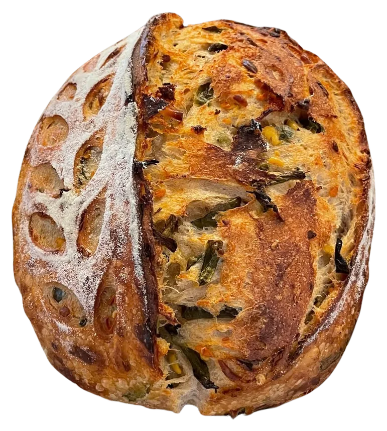 Jalapeno and cheese inclusion sourdough loaf, cut open to show the crumb