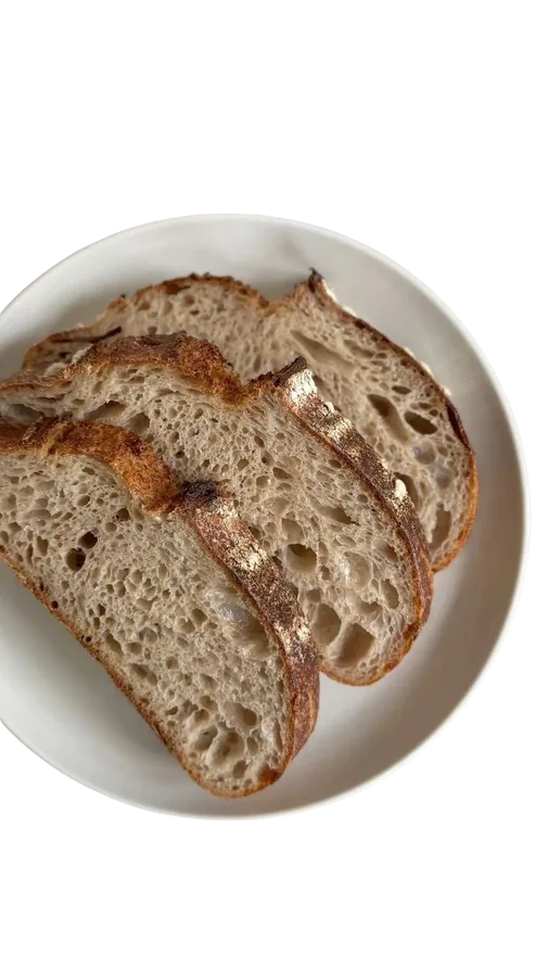Plate of sliced country sourdough showing an open crumb