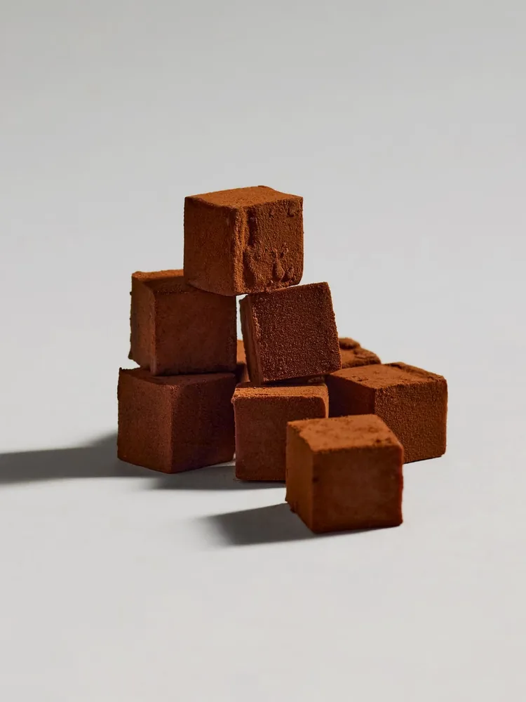 A stack of cocoa-dusted pure chocolate truffle cubes